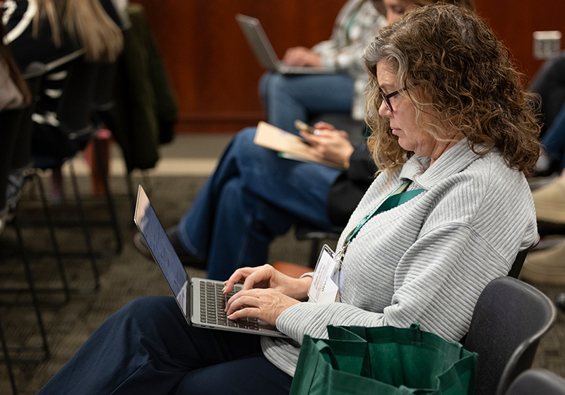Attendee sitting at conference.