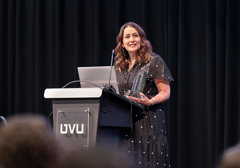 Presenter speaking at podium.