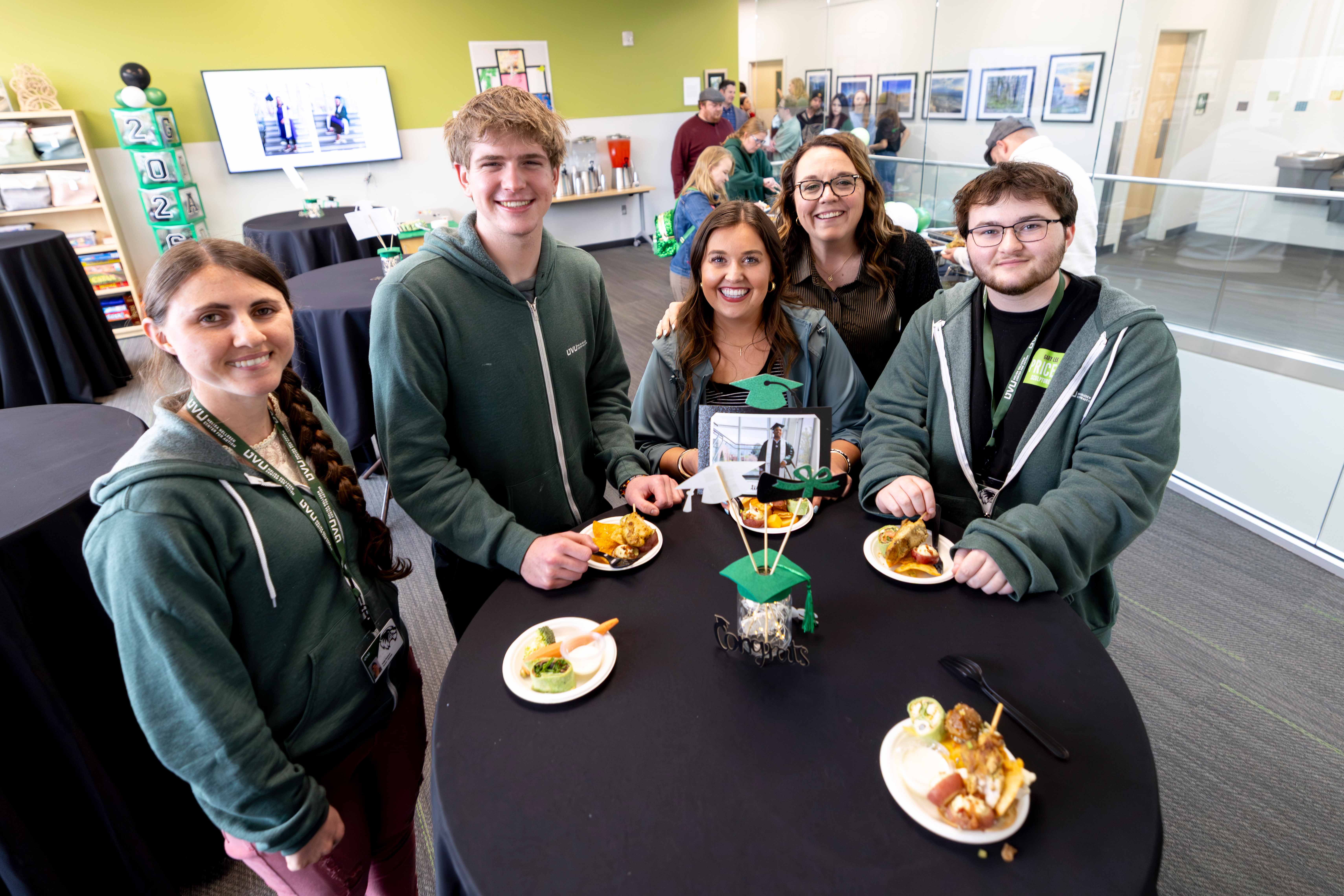 Group of people around table at WE graduation