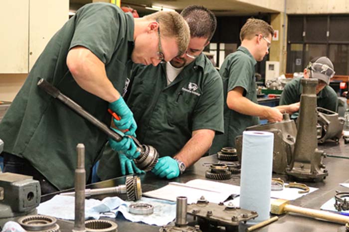 auto tech students working with auto parts