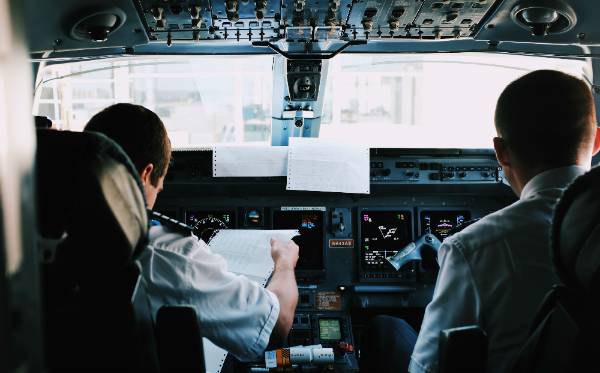 Airline pilots in cockpit preparing for flight