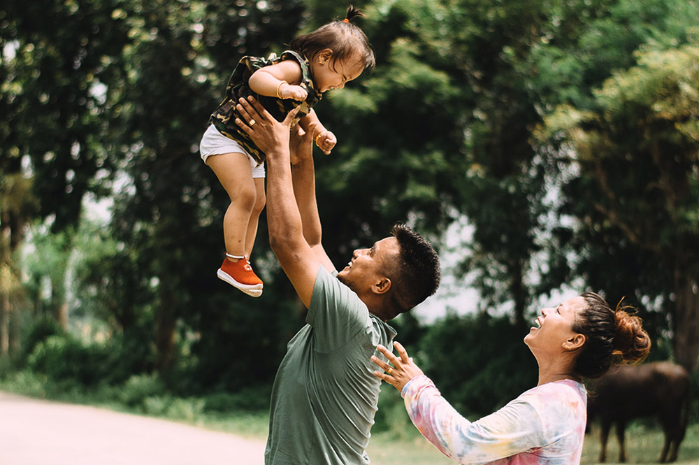 father throwing daughter into the air