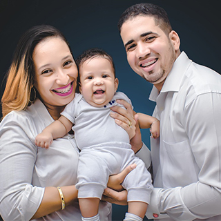 man and woman holding a baby