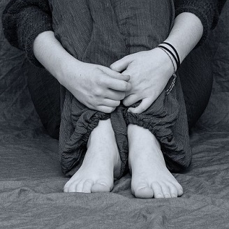 a persons arms wrapped around thier legs