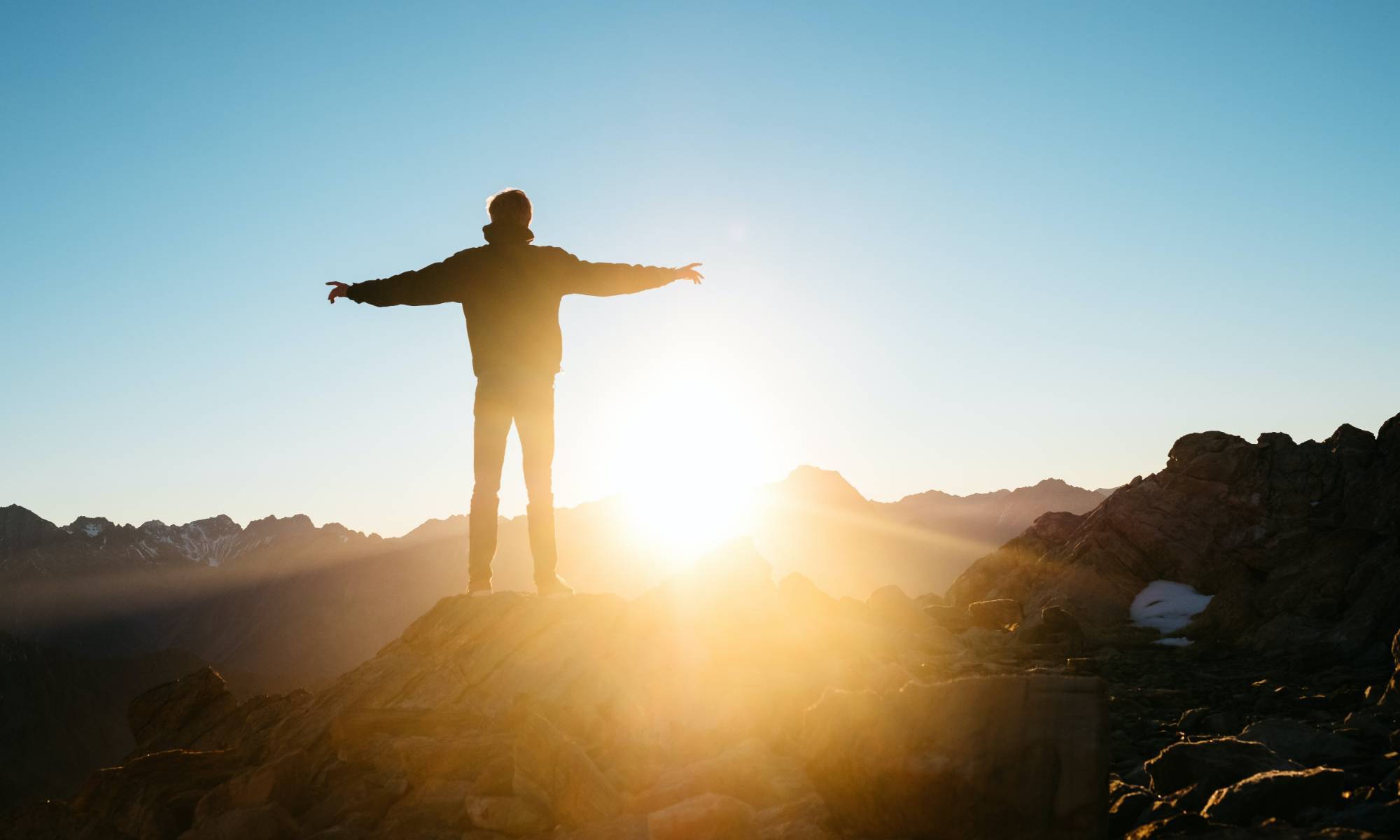 man standing on mountain in the morning