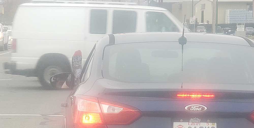 driver's foot sticking out of the car window