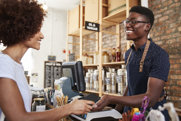 women handing someone her credit card