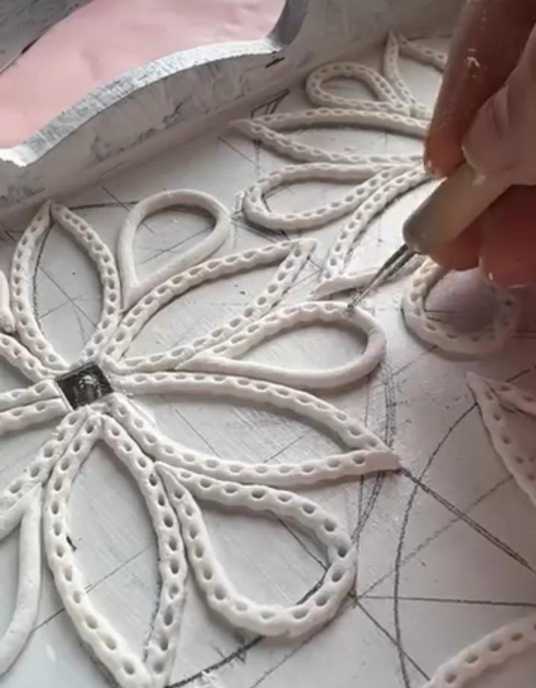 indivigual in the process of creating design for mud mirror