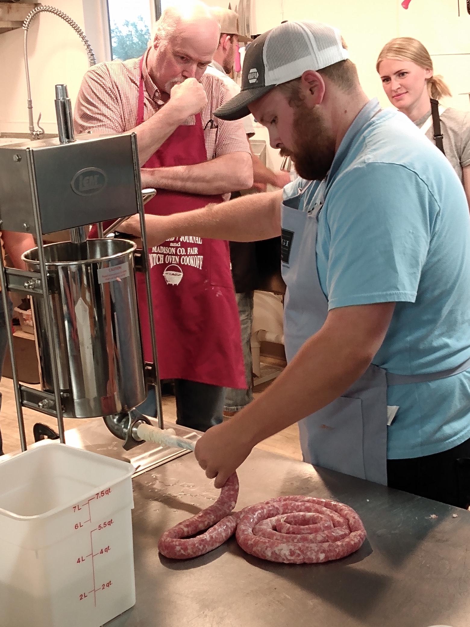 Man making sausage with peers