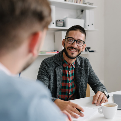 Workers talking at a desk