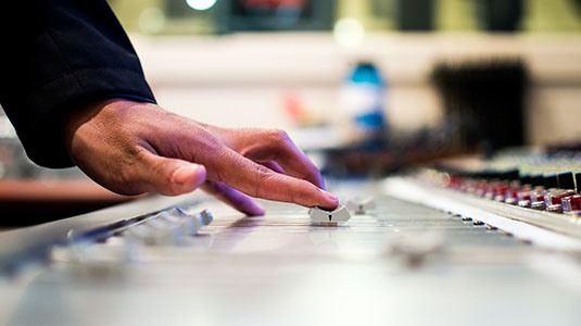 student using an audio editing station