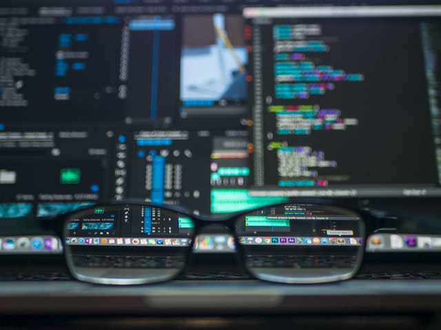 Computer screen with glasses on the keyboard