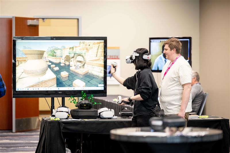 Girl using a VR headset on a large TV with a man standing next to her