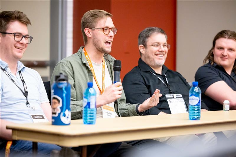 People sitting at a table taking questions form the audience