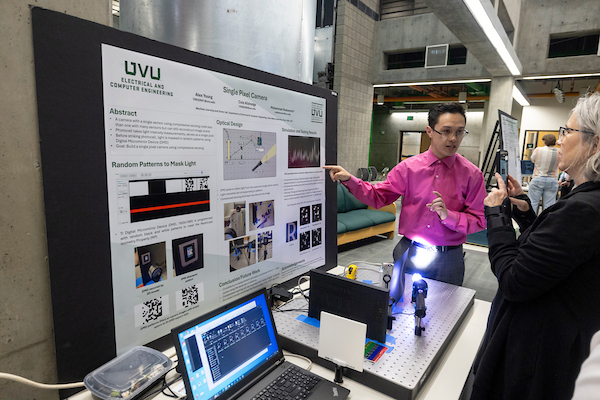 student presenting a project poster