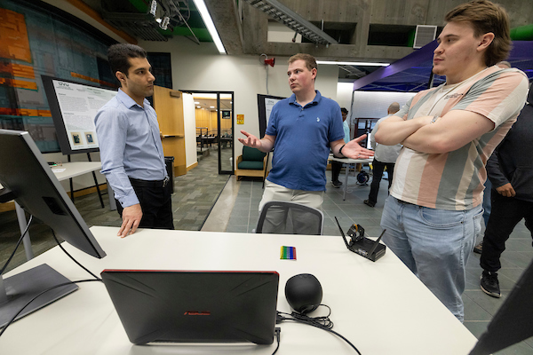 group of people standing around a table