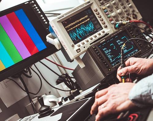 engineer working on computer and other devices