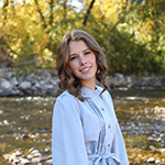 woman standing outdoors by a river