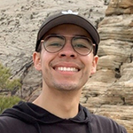 man in front of a rock canyon