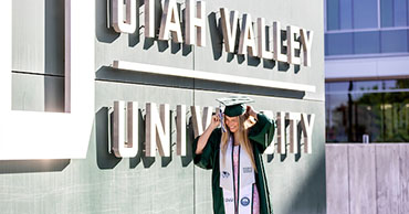 woman wearing graduation robes and cap