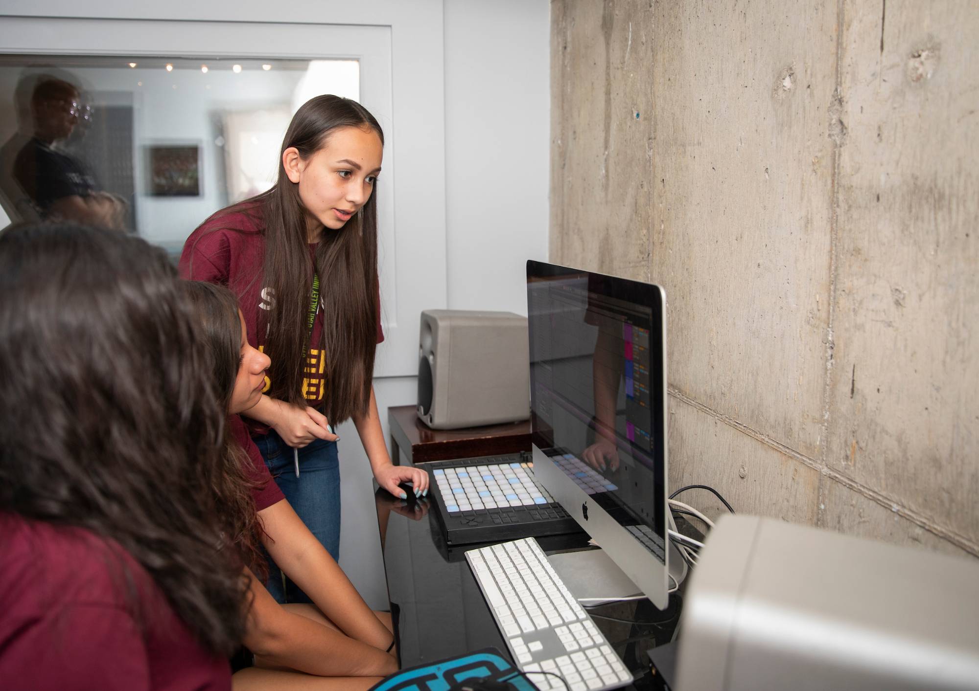 Female STEM students looking over a computer project