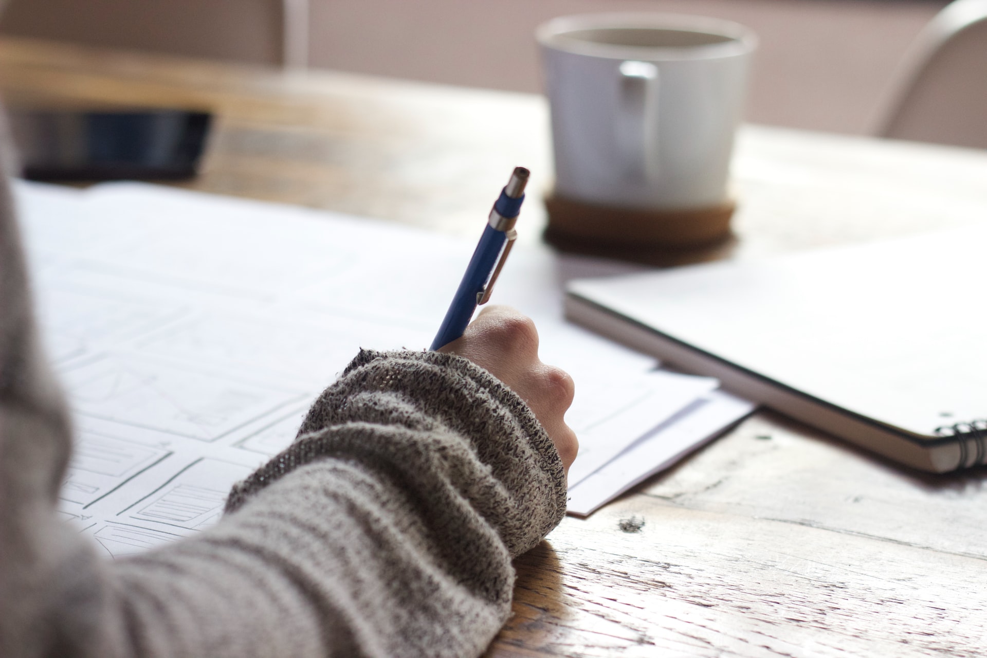 person writing on piece of paper