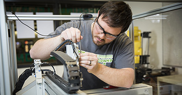 man working with electronics equipment