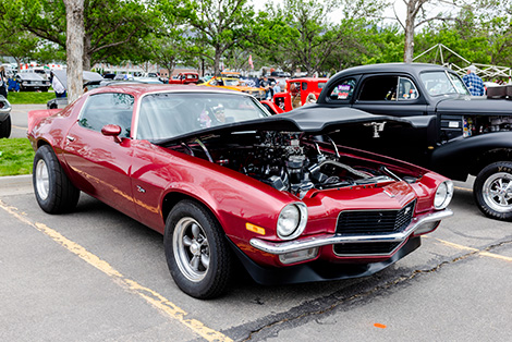 red muscle car with hood lifted