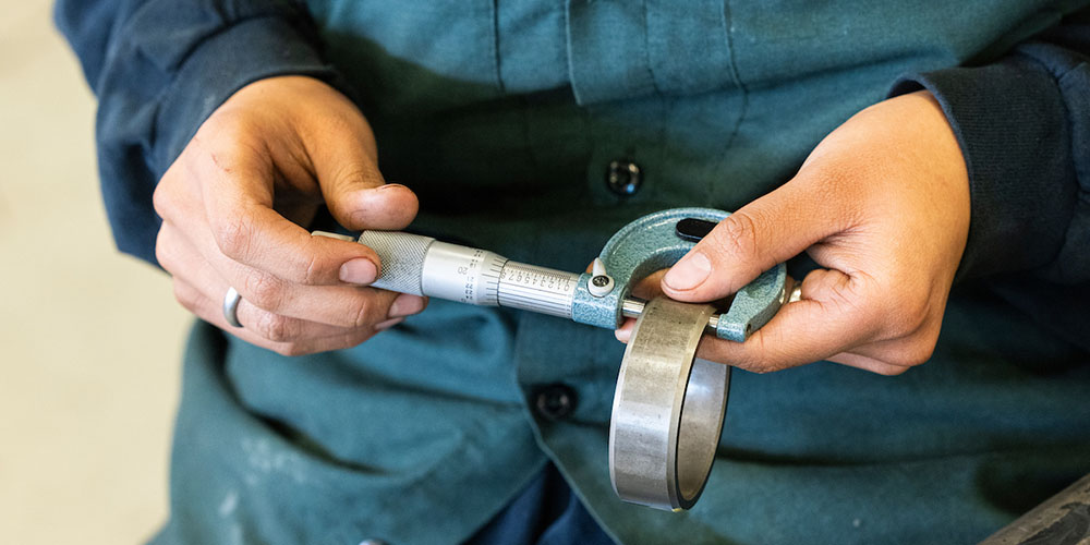 close up of hands holding a wrench