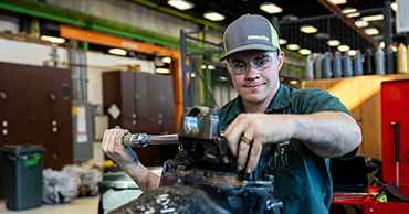 man working on a car part
