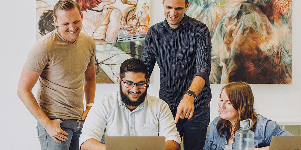 group of people looking at a computer