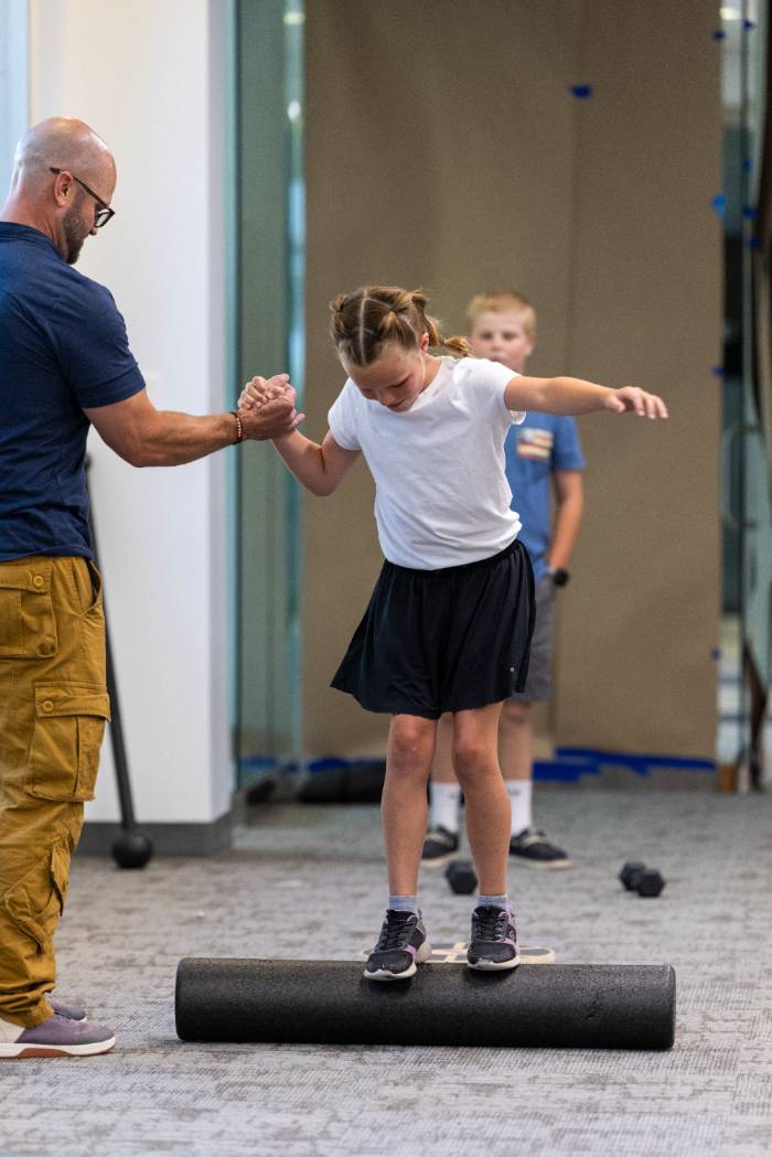Girl walking on a rolling cylinder