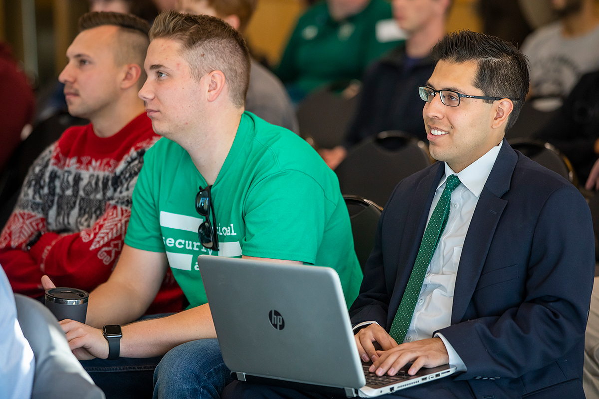 Students take notes at the cybersecurity conference