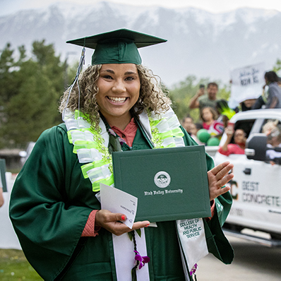 Student holding diploma at graduation