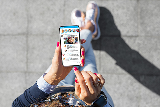 feminine hands scrolling social feed