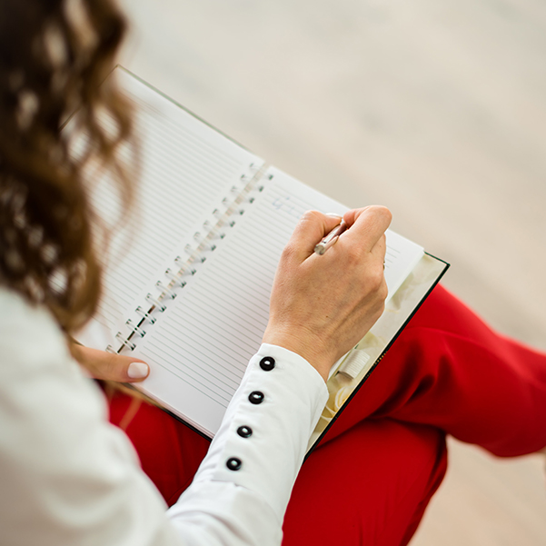 woman writing in a notebook