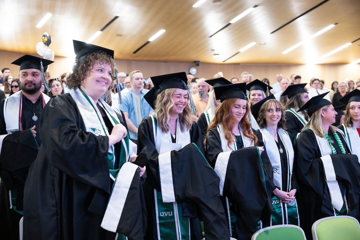 Happy group of graduates at their hodding ceremony.