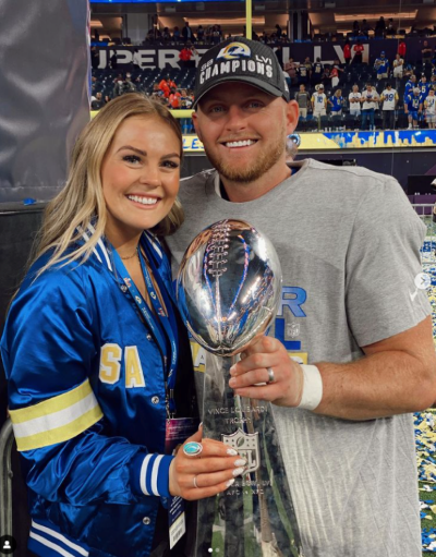 Matt Gay and his wofe holding a trophy at the super bowl