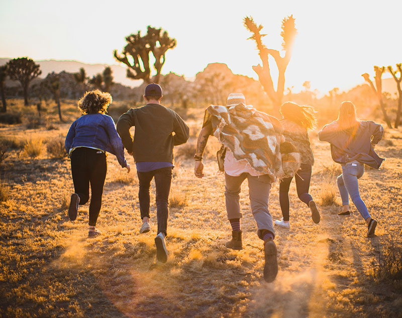 group of students running along hiking path