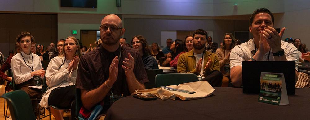 Conference attendees clapping for a speaker