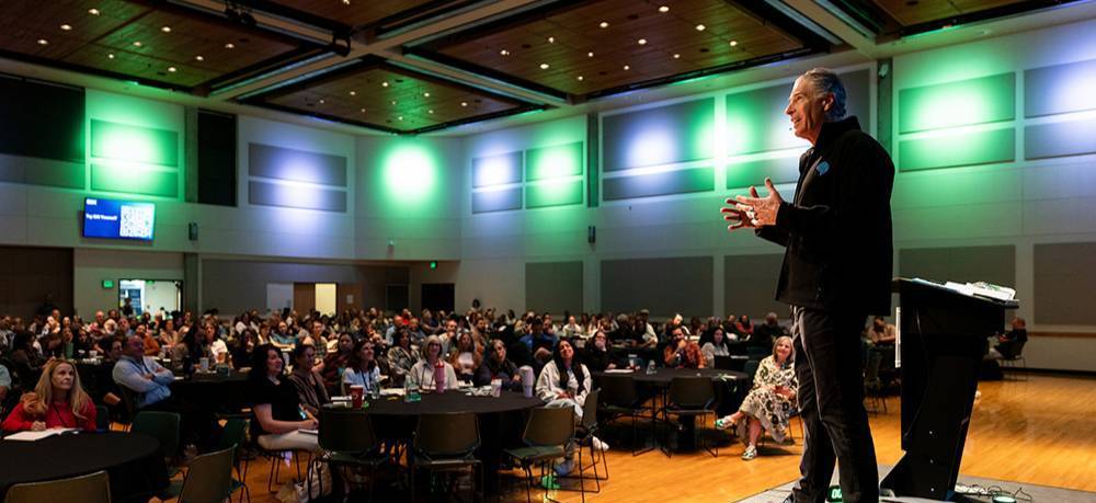 Conference speaker presenting to conference attendees