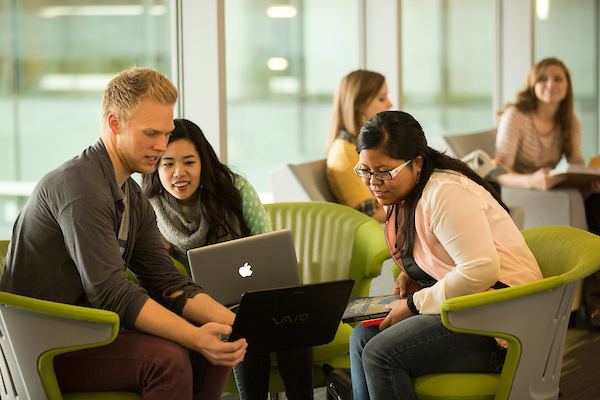 3 students working on a laptop