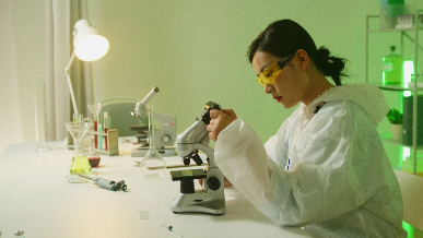 Student looking through a microscope