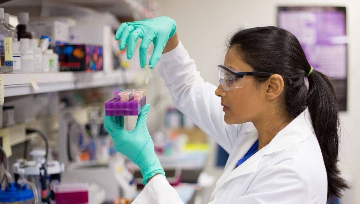 Chemist holding vials of liquid