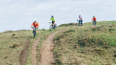 People mountain biking