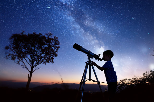 Child looking through telescope