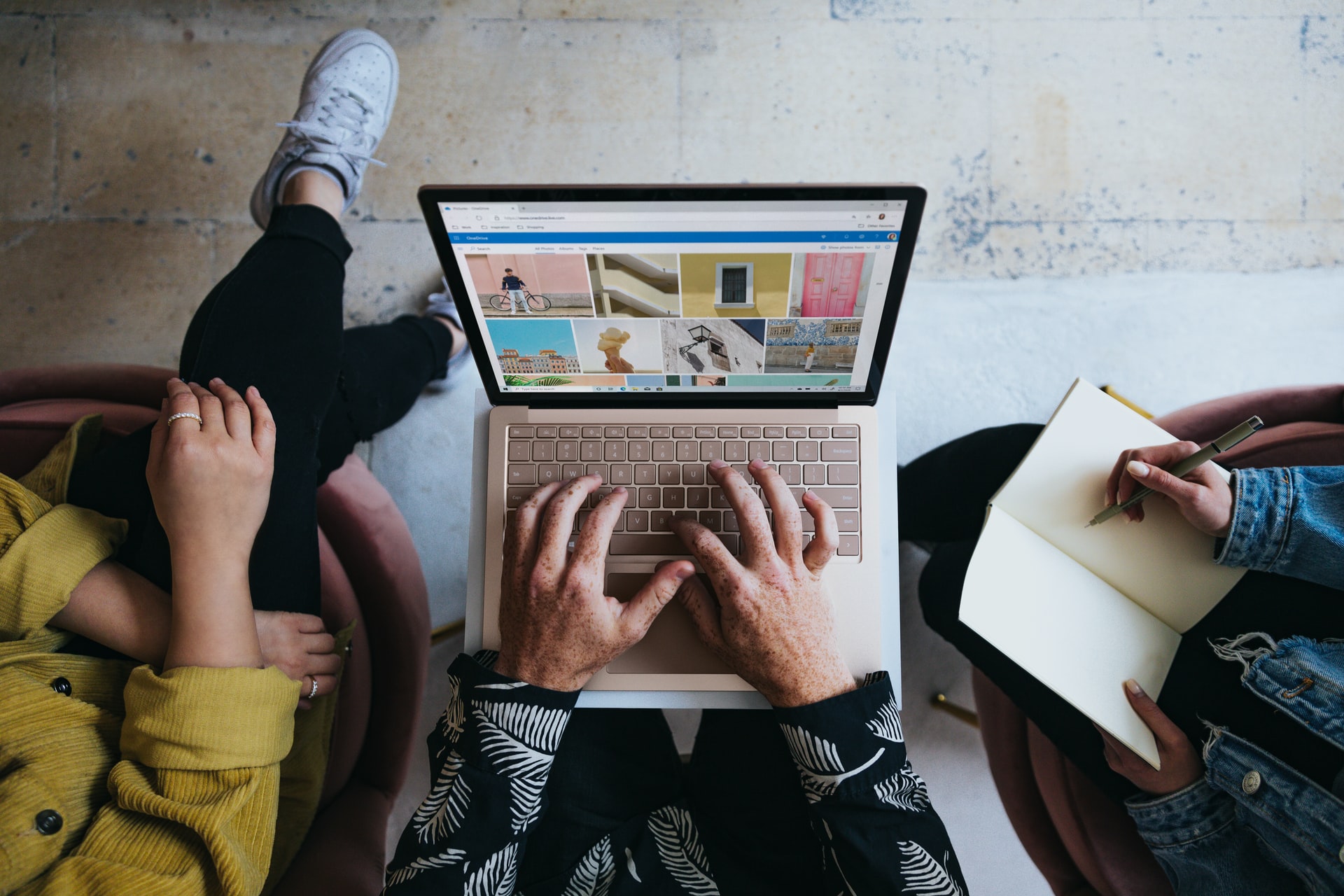 Hands typing on a laptop