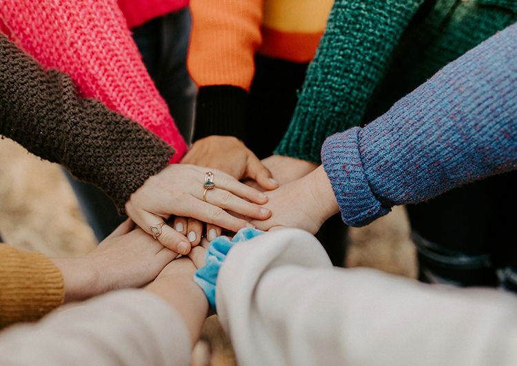 group putting their hands together