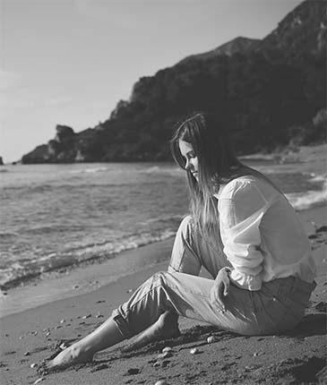 Girl sitting on the beach