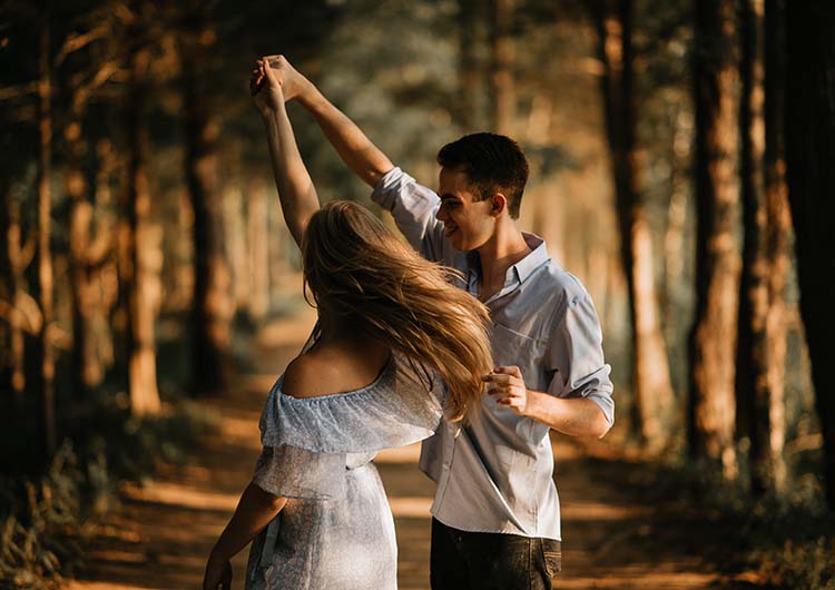 A couple dancing in the forest
